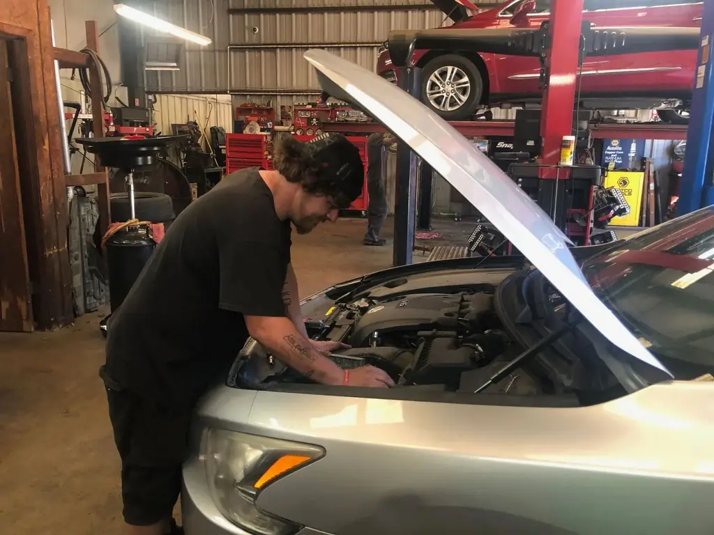 Two lifts working inside the Baxley's Auto Repair shop in Benton, one car up on the rack